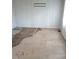 An empty room with damaged flooring and a bracket on the wall for mounting a TV at 208 Essex Rd, Nashville, NC 27856