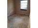 An empty bedroom needing renovation, featuring damaged floors and natural light at 208 Essex Rd, Nashville, NC 27856