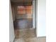 A peek into the living room, showcasing the worn flooring and an older light fixture at 208 Essex Rd, Nashville, NC 27856