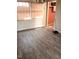 Bright living room showcasing newly installed light brown laminate flooring and windows at 208 Essex Rd, Nashville, NC 27856