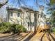 Two-story home showcasing a wooden deck, bright windows, and neutral siding at 215 Longbridge Dr, Cary, NC 27518