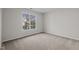 Neutral bedroom features carpet, a bright window, and base molding at 215 Longbridge Dr, Cary, NC 27518