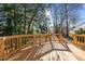View of a wooden deck and surrounding trees showcasing outdoor living space and natural landscape at 215 Longbridge Dr, Cary, NC 27518