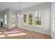 Sun-drenched dining area with views of the outdoors through three large windows and a glass-paned door at 215 Longbridge Dr, Cary, NC 27518