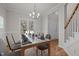 Bright and airy dining room with hardwood floors and a large window overlooking the front yard at 215 Longbridge Dr, Cary, NC 27518