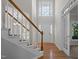 Bright foyer boasts a soaring window above the front door and a staircase with wooden railing at 215 Longbridge Dr, Cary, NC 27518
