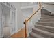 Inviting entryway with a staircase, hardwood floors, and french doors leading to another room at 215 Longbridge Dr, Cary, NC 27518