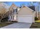 Exterior featuring a two-story home with vinyl siding, attached garage, and a concrete driveway at 215 Longbridge Dr, Cary, NC 27518