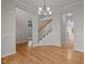 Spacious foyer with hardwood floors, open staircase, and views into the living spaces at 215 Longbridge Dr, Cary, NC 27518