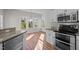 Sunlit kitchen features stainless steel appliances, granite countertops, and beautiful wood-look flooring at 215 Longbridge Dr, Cary, NC 27518