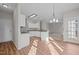Open kitchen area with breakfast bar, white cabinets, stainless steel appliances, and lots of natural light at 215 Longbridge Dr, Cary, NC 27518