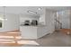 Bright kitchen featuring white cabinetry, granite countertops, and a breakfast bar at 215 Longbridge Dr, Cary, NC 27518