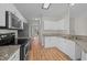 Bright kitchen with stainless appliances, granite countertops, and white cabinetry offers ample counter space at 215 Longbridge Dr, Cary, NC 27518