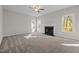 Comfortable living room with a ceiling fan, fireplace, and large windows for ample natural light at 215 Longbridge Dr, Cary, NC 27518
