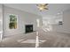 Open concept living room boasts a fireplace, large windows, and flows into the kitchen area at 215 Longbridge Dr, Cary, NC 27518