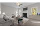 Comfortable living room with a ceiling fan, fireplace, and large windows for ample natural light at 215 Longbridge Dr, Cary, NC 27518
