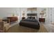 Staged main bedroom has neutral walls, carpet, and two bright windows at 215 Longbridge Dr, Cary, NC 27518