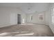This large bedroom has neutral carpet, bright windows, and access to a walk-in closet at 215 Longbridge Dr, Cary, NC 27518