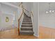 A well-lit staircase with carpeted steps and wooden railings connects the home's levels at 215 Longbridge Dr, Cary, NC 27518