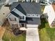 Aerial view of a two-story home with a driveway and manicured front lawn at 2344 Lazy River Dr, Raleigh, NC 27610