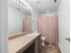 Well-lit bathroom with a single sink vanity and a shower and tub combination at 2344 Lazy River Dr, Raleigh, NC 27610