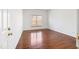 An empty bedroom, with wood floors, a light-filled window, and a gold door knob at 2344 Lazy River Dr, Raleigh, NC 27610