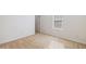 Neutral bedroom features an access door and a window for natural light at 2344 Lazy River Dr, Raleigh, NC 27610