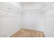 Empty closet with multiple rows of wire shelving and beige carpeted floors at 2344 Lazy River Dr, Raleigh, NC 27610