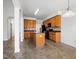 Spacious kitchen with central island, wood cabinets, and black appliances at 2344 Lazy River Dr, Raleigh, NC 27610