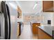 Kitchen view with stainless steel refrigerator, wood cabinets, and island at 2344 Lazy River Dr, Raleigh, NC 27610