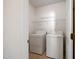Functional laundry room includes a washer, dryer, and wire shelving at 2344 Lazy River Dr, Raleigh, NC 27610