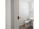 Clean powder room featuring modern fixtures, toilet, and sink at 2344 Lazy River Dr, Raleigh, NC 27610