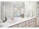 Bright bathroom features a dual sink vanity with modern fixtures and a large mirror at 2515 Maplemere Ct, Durham, NC 27703
