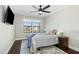 Cozy bedroom features a ceiling fan, carpet flooring, a large window, and a comfortable queen-size bed at 2515 Maplemere Ct, Durham, NC 27703