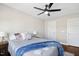 Relaxing bedroom features a ceiling fan, carpet flooring, a large window, and a comfortable queen-size bed at 2515 Maplemere Ct, Durham, NC 27703