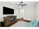 Bonus room with built in fireplace, ceiling fan, and hardwood floors at 2515 Maplemere Ct, Durham, NC 27703