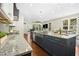 Open kitchen layout with granite countertops, stainless steel sink and view to dining and living areas at 2515 Maplemere Ct, Durham, NC 27703