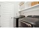 Modern laundry room with Samsung washer and dryer, built-in shelving and ample storage space at 2515 Maplemere Ct, Durham, NC 27703