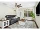 Cozy living room with wood floors, a ceiling fan, and a view of the backyard at 2515 Maplemere Ct, Durham, NC 27703