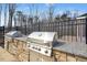 Outdoor kitchen area with built in stainless steel grill, granite countertop, and stone accents at 2515 Maplemere Ct, Durham, NC 27703