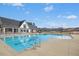 Large community pool with ample deck space and a well-maintained clubhouse in the background at 2515 Maplemere Ct, Durham, NC 27703