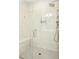Close up of the shower with tiled walls, shower seat, and shampoo and soap dispensers at 2515 Maplemere Ct, Durham, NC 27703