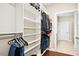 Walk-in closet with custom shelving and clothing racks and hardwood floors at 2515 Maplemere Ct, Durham, NC 27703