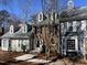 Charming townhome featuring a brick facade, dormer windows, and well-maintained landscaping at 2835 Bedfordshire Ct, Raleigh, NC 27604