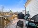 Outdoor deck with furniture and a grill overlooking backyard and serene wooded area at 285 Scotland Dr, Youngsville, NC 27596
