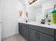 A well-lit bathroom is complete with double sinks, quartz countertops, modern fixtures, and soft grey cabinetry at 285 Scotland Dr, Youngsville, NC 27596