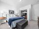 Comfortable bedroom with a padded bench, neutral carpet, and an open closet with a workspace at 285 Scotland Dr, Youngsville, NC 27596