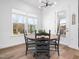 Cozy dining nook with a round table, black spindle chairs, and bright natural light from large windows at 285 Scotland Dr, Youngsville, NC 27596