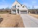 Charming two-story home with a gray trim and stone accents at 285 Scotland Dr, Youngsville, NC 27596