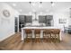 Bright kitchen features gray cabinets, quartz countertops, and island seating for casual dining and socializing at 285 Scotland Dr, Youngsville, NC 27596